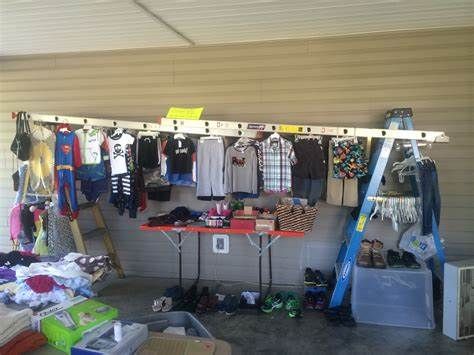 Using Ladders To Display Clothes at Garage Sale